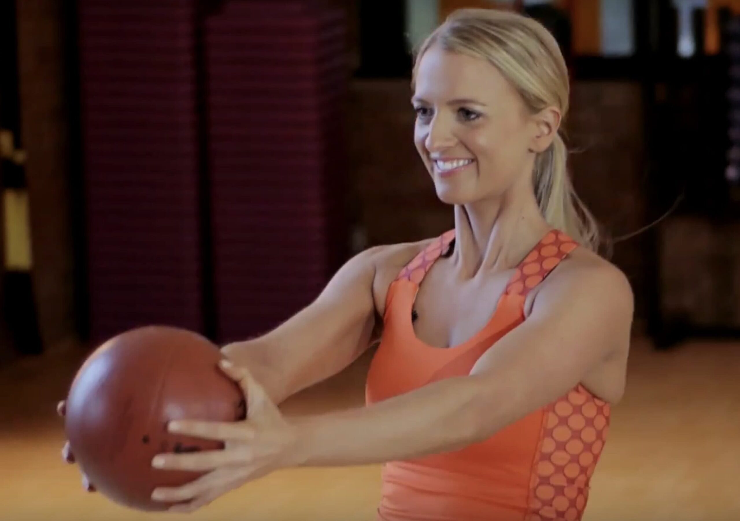 Holly Roser using a medicine ball in her signature H-Method class.