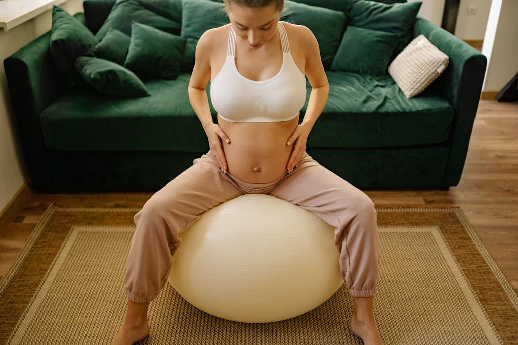 10 Expectant mother practicing prenatal exercises with a yoga ball at home, emphasizing fitness and well-being.